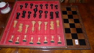 A leather cased chess set wooden Staunton style pieces complete