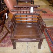 A Chinese hardwood open armchair with carved detail