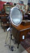 A large chromium studio tripod lamp
