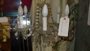A cut glass six branch chandelier with hanging lustres