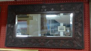 An Oriental needlework arrangement and carved mirror and bagatelle board