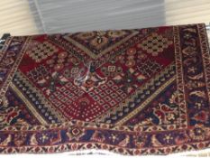 A fine North West Persian Bakhtar rug central pendant medallion on a terracotta field within
