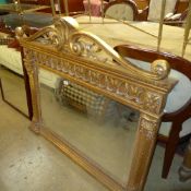 A Regency style giltwood overmantel mirror the scroll pediment above bevelled plate