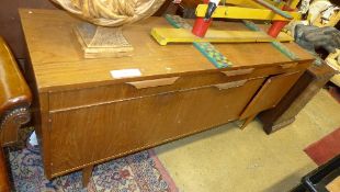 A teak Danish design sideboard with frieze drawers above cupboards