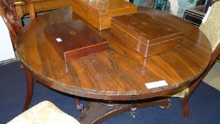 A Victorian rosewood breakfast table the circular top raised on triform base