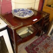A C20th French drinks trolley with glass detachable tray united by mirrored undertier