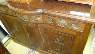 A late Victorian oak breakfront sideboard with carved drawers above panel doors (reportedly from