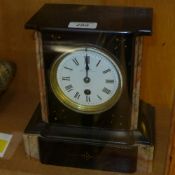 A black marble mantle clock