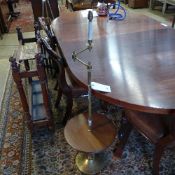 A C20th mahogany and brass standard lamp with a pleated tartan shade