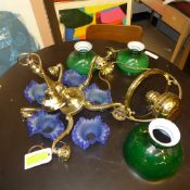 A collection of chandeliers and wall lights with glass shades