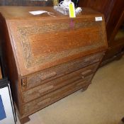 An oak  bureau with fall front fitted interior over three drawers