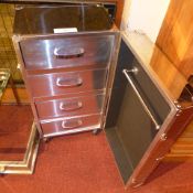 A chrome cabinet raised on castors and enclosing four shelves and a hanging rail