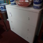 A white contemporary designer chest fitted three drawers on plinth support