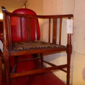 An Edwardian inlaid mahogany tub form chair with pad seats upholstered in tapestry fabric on