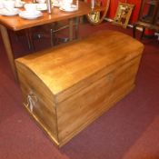 An old pine dome top seamans trunk with twin handles