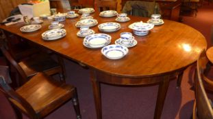 A George III mahogany dining table with demi lune ends and three leaves raised on square section