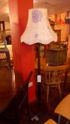 A mahogany standard lamp with silk shade