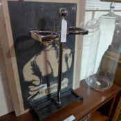 A chrome twin stickstand on cast iron supports