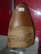 An Arts and Crafts vase of arched shape with landscape decoration in relief