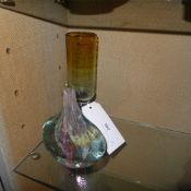 An antique coloured glass with hollow stem having steel balls within and a similar