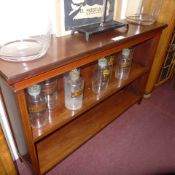 An inlaid mahogany dwarf bookcase with adjustable shelves on tapering supports