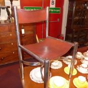 A set of four Italian designer chairs upholstered in tan leather on chromed supports