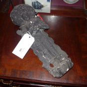 An Eastern black painted plaster figure of a deity