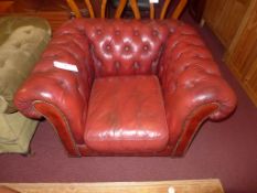 A Chesterfield armchair upholstered in buttoned red leather