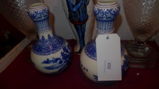 A pair of Chinese blue and white vases decorated with pictoral reserves