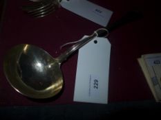 A hallmarked silver and gilt sauce ladle of large size