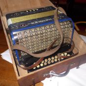 A Hohner accordion in pine case