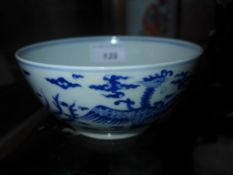 A Chinese blue and white bowl decorated with dragons and mythical birds