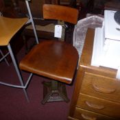 A singer cast iron and plywood machinists chair