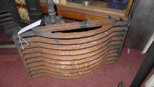 A cast iron fire grate and pair of fire dogs