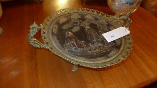 A C19th French gilt metal charger with extensive pierced detail and Oriental scene in relief