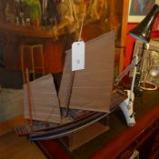 A scale model sailing boat on stand