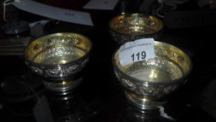 A set of three hallmarked Scottish silver salts with embossed decoration