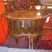 A retro walnut tray top cabinet with bevelled glazed sides on cabriole supports