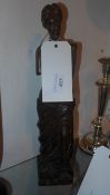 A carved wooden Spanish statuette of a lady