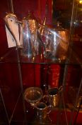 A silver plated four piece tea set with engraved detail and a silver plated coaster