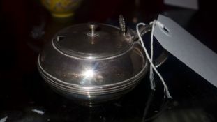 A hallmarked silver inkwell with blue glass liner