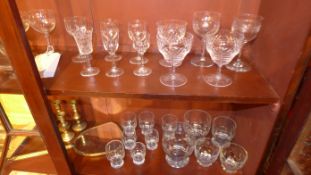A large collection of various glassware, brass candlesticks and similar items