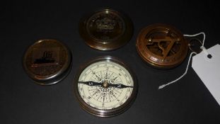 A set of three various compasses