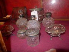 A collection of silver lidded perfume bottles, jars and similar as well as two silver plated bon bon