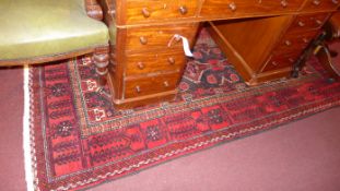 A fine NorthEast Persian meshad Belouch rug 245 cm x 120 cm bearing repeating motifs within stylised