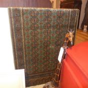 A Keshan design carpet with a flowerhead medallion on a midnight blue field with floral designs