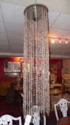 A contemporary designer hanging light with string lustres