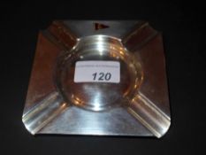 A hallmarked silver ashtray with inset flying flag bearing crown and harp detail