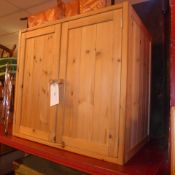 A pair of contemporary pine cabinets fitted pair of panel doors enclosing shelves