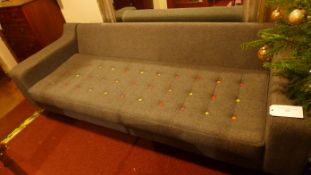 A contemporary Naught One Italian design sofa upholstered in grey with a buttoned seat raised on